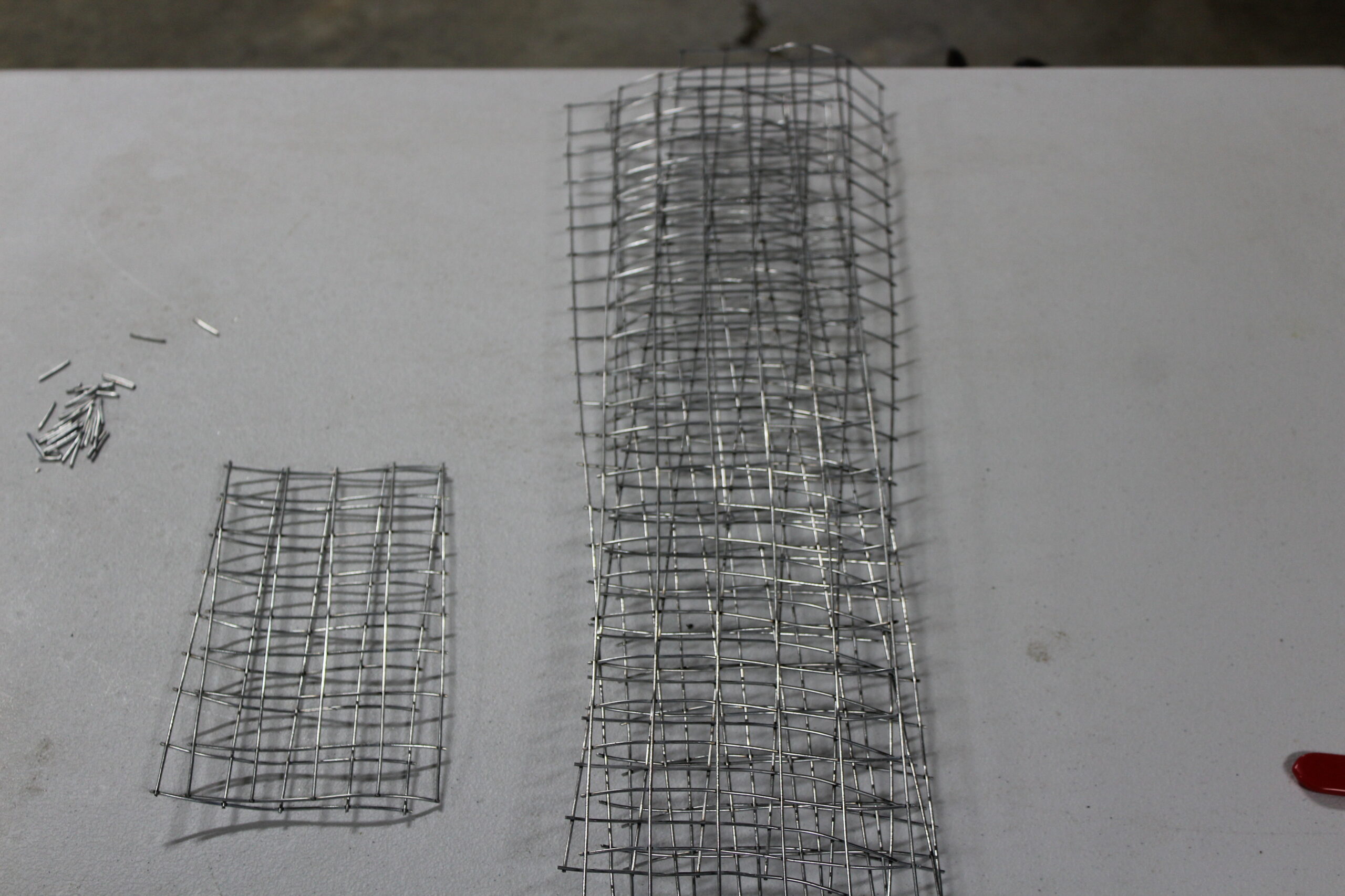 Cut wire panels for a DIY muskrat sets collapsible colony trap with four walls and two doors