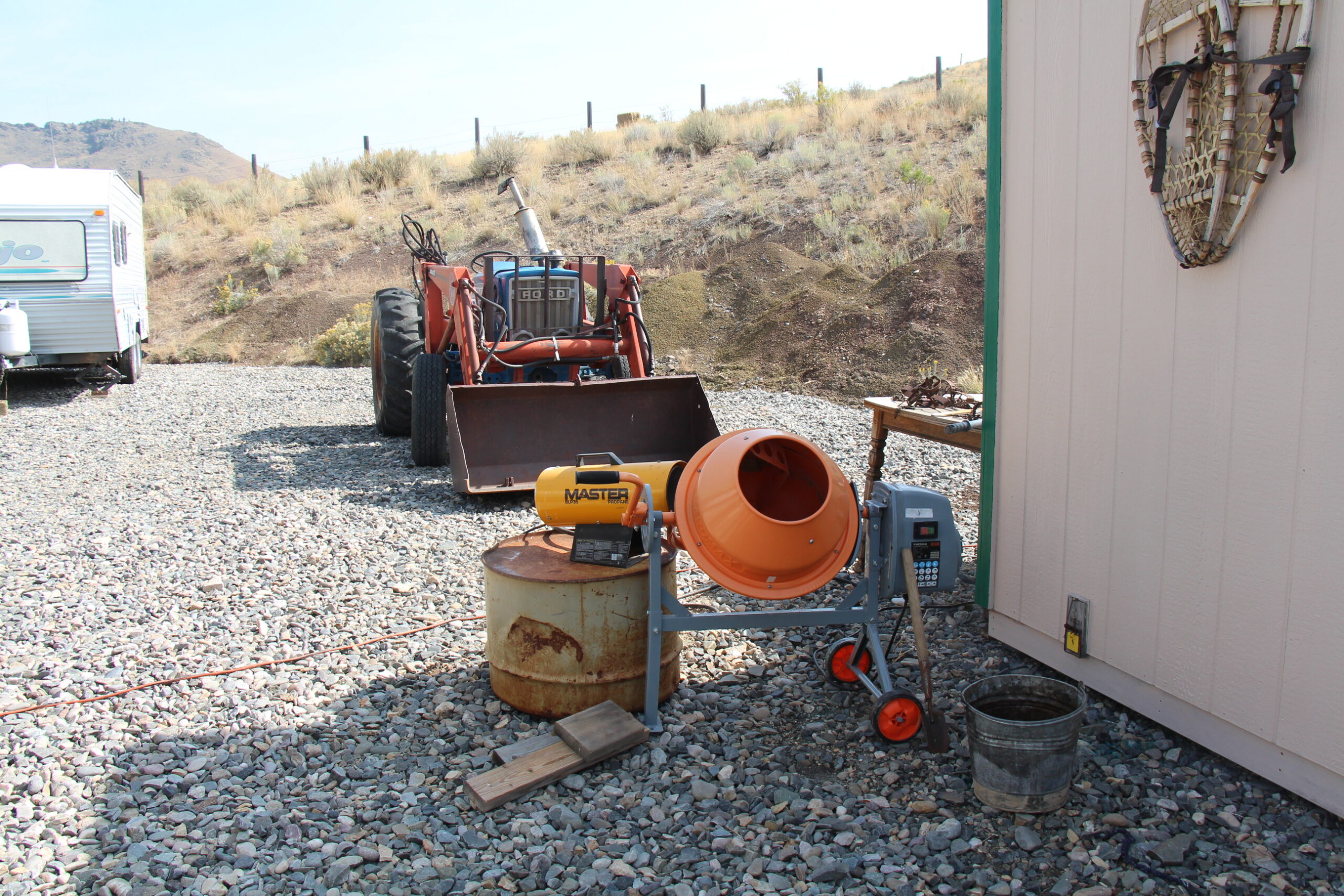 Cement mixer setup with heat source used for making waxed dirt for trapping